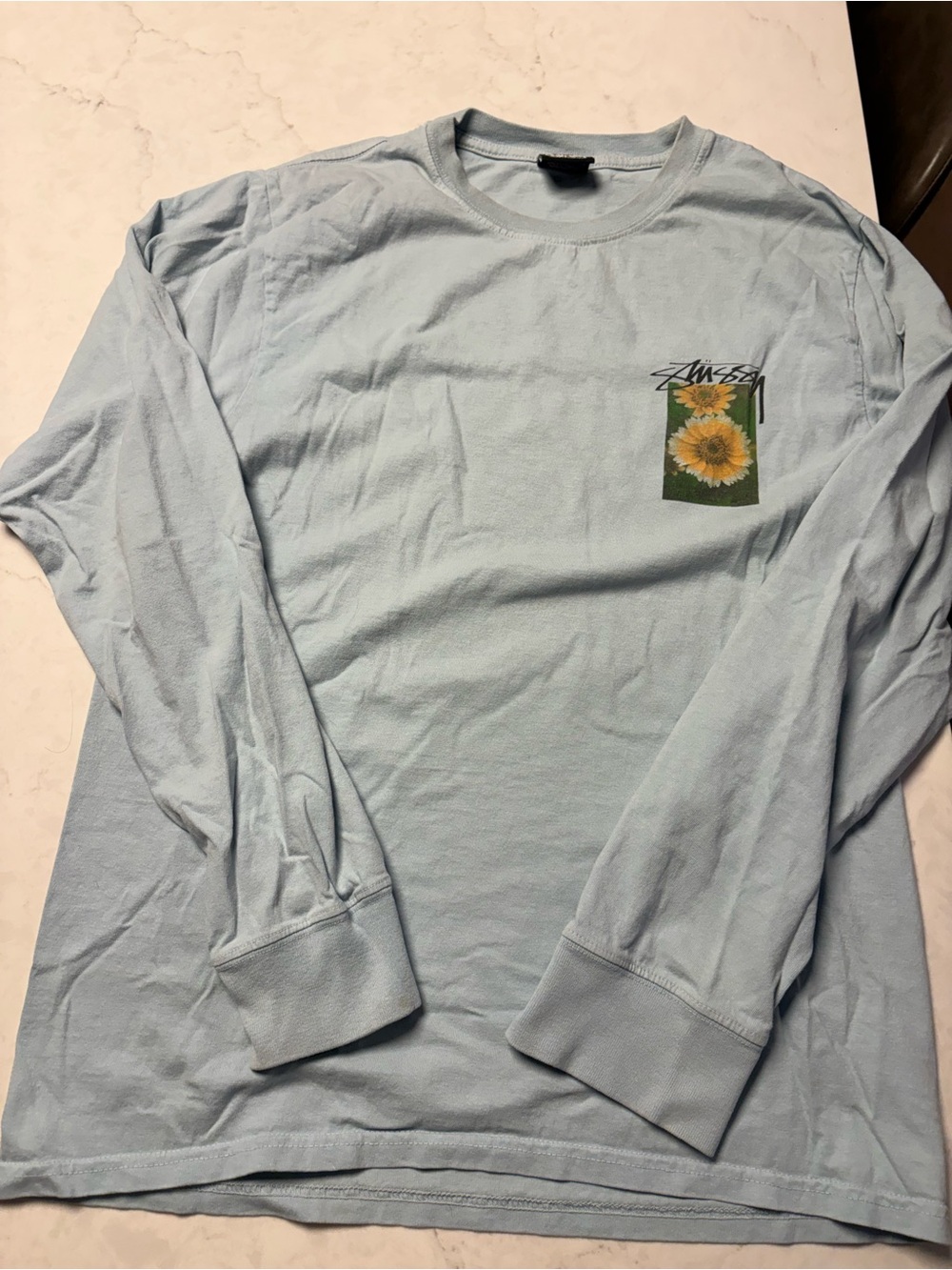 Stussy Light Blue Long Sleeve Tee with Sunflower Chest Graphic